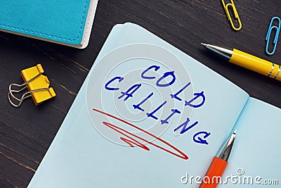 Business concept about COLD CALLING with sign on the sheet. Cold callingÂ typically refers to solicitation by phone or Stock Photo